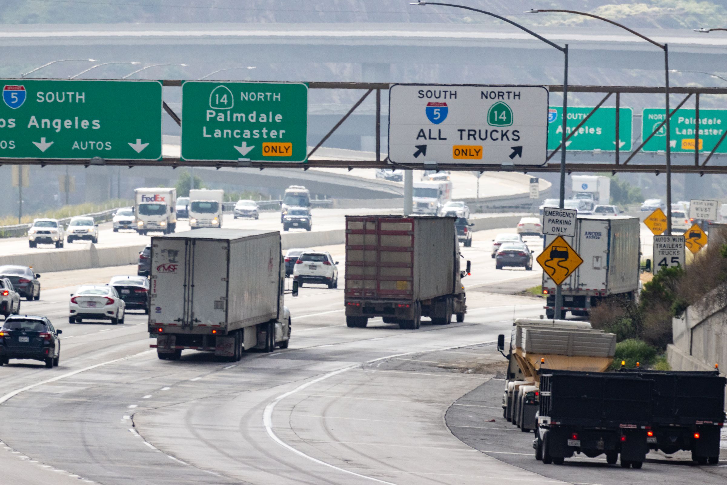 Freight trucks traveling on a Southern California freeway